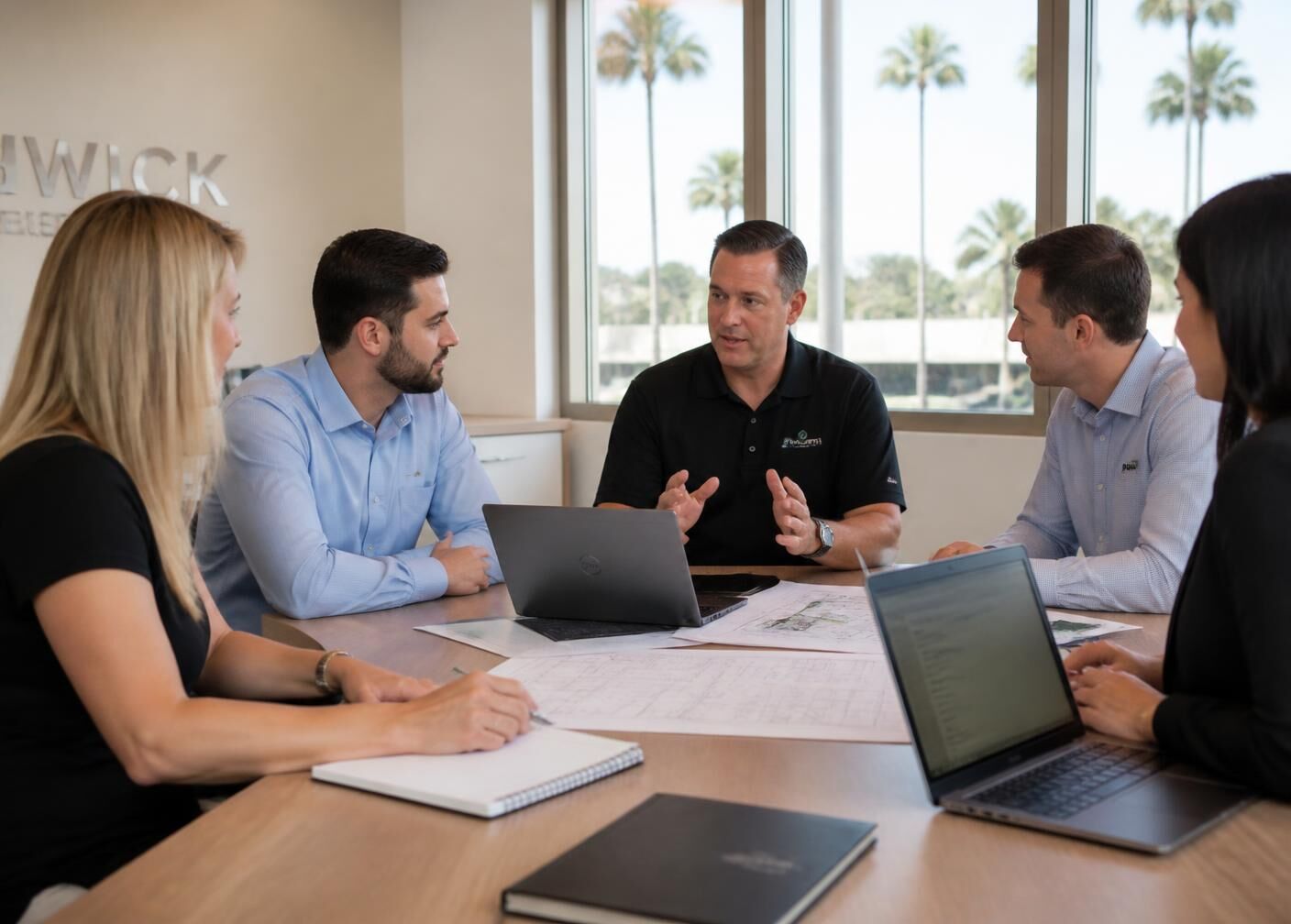 INGG consultants reviewing site drawings with a client team in Tallahassee